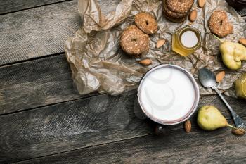 Almonds pears Cookies and milk on wooden table. Rustic style and autumn food photo