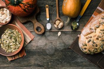 Rustic style pumpkins with bread and seeds on wood. Autumn Season food photo