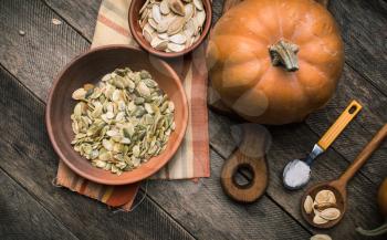 Rustic style pumpkins with seeds on wood. Autumn Season food photo