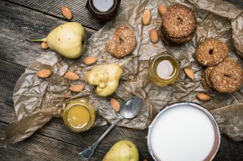 Tasty Pears nuts Cookies and joghurt on rustic wood. Rustic style and autumn food photo