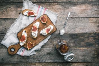 Bruschetta snacks with jam and figs on napkin on napkin. Breakfast, lunch food photo