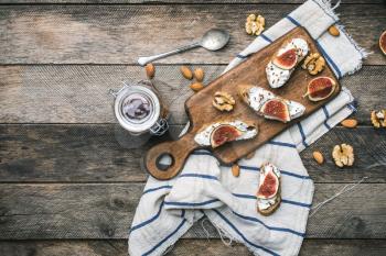Bruschetta snacks with nuts jam and figs on napkin. Breakfast, lunch food photo