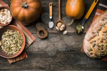 Rustic pumpkins with bread and seeds on wood. Autumn Season food photo