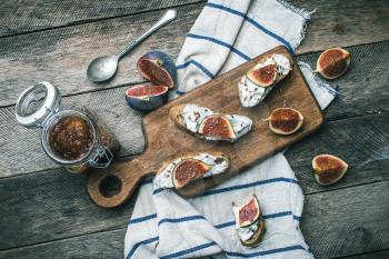 cut figs and Bruschetta snakcs with jam and on napkin. Breakfast, lunch food photo