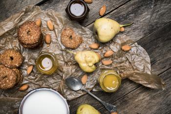 Healthy Pears almonds Cookies and milk on rustic wood. Rustic style and autumn food photo
