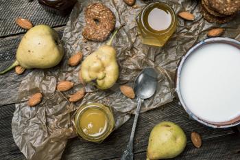 Cookies pears and yoghurt on wooden table. Rustic style and autumn food photo