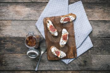 rustic style Bruschetta snack with jam and figs on napkin. Breakfast, lunch food photo