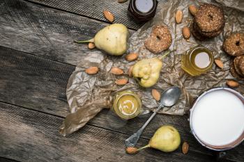 Pears Cookies Almonds and milk on wooden table. Rustic style and autumn food photo
