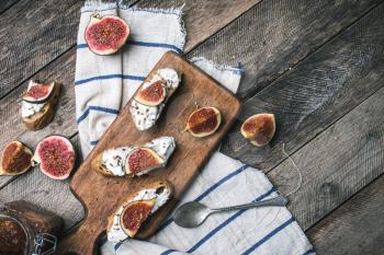 rustic style Bruschetta snacks with cheese and figs on napkin in rustic style. Breakfast, lunch food photo