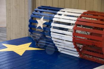 Royalty Free Photo of a Lobster Trap With the Acadian Flag on It