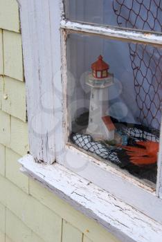 Royalty Free Photo of a Figurine of a Lighthouse in a Window