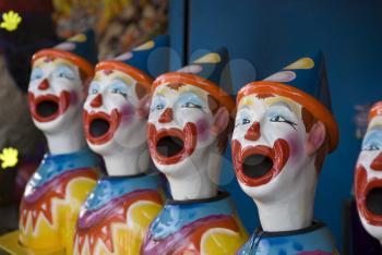 Royalty Free Photo of a Row of Plastic Clown Heads