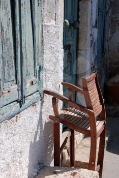 Royalty Free Photo of a Folding Chair Against a Wall in Kastellorizo, Greece