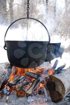Royalty Free Photo of Kettles Over Open Fires
