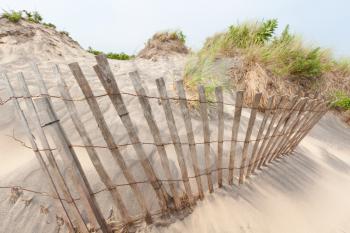 Royalty Free Photo of a Fence on a Sand Dune