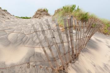 Royalty Free Photo of a Fence on a Sand Dune