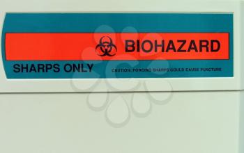 Biohazard label on sharps container in the medical office.
