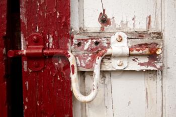Old painted lock on the barn doors.