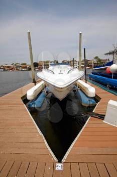 A view of the private yacht's bow, docked in the marina.