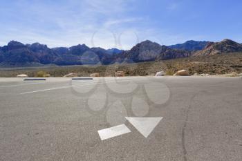 Directional arrow on the empty parking lot in Mojave Desert, Nevada.