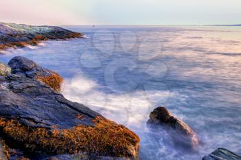 Long exposure image of sunset on a rocky shore