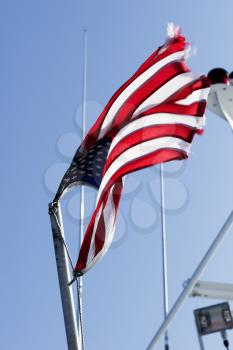 Weathered American flag on a flag pole.