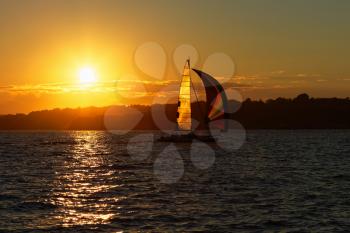 Sail boat at sunset on the ocean.