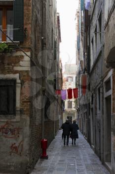 Venice, Italy - April 1, 2013: Street views of ancient architecture in Venice, Italy. Venice is a city in northeastern Italy sited on a group of 118 small islands separated by canals and linked by bri