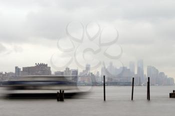 New York, USA-June 2, 2015: East River Ferry coming in for docking on a foggy day.