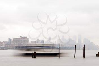 New York, USA-June 2, 2015: East River Ferry coming in for docking on a foggy day.