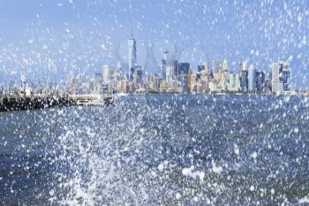 Manhattan skyline through the ocean spray.