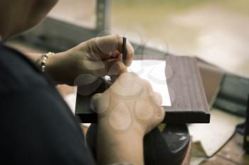 Toledo, Spain- November 04, 2015: Artisan jewelers creating hand made jewelry items in a workshop.