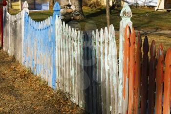 Colorful picket fence on a farmland.