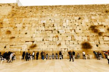 Jerusalem, Israel-March 14, 2017: Jews pray at The Western Wall - the holiest place where Jews are permitted to pray, though it is not the holiest site in the Jewish faith, which lies behind it, on Te