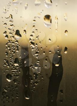 Water drops and sunlight on window glass