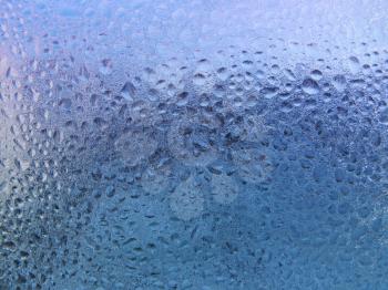 water drops and frost on window glass