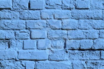 the painted blue old brick wall