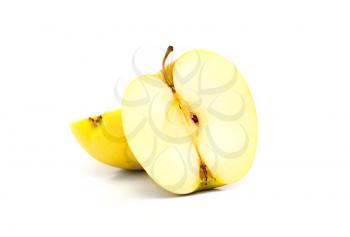 close up of half yellow apple on white background