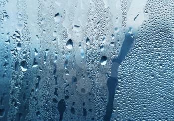 large and fine water drops on glass