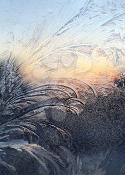 ice patterns and sunlight on winter glass