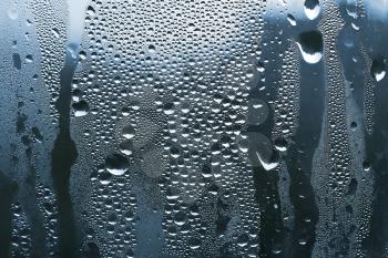 close up of water drops on glass background