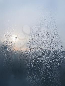 Water drops and sunlight on window glass