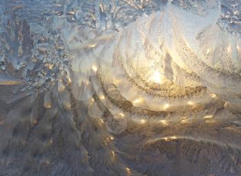 Frost and sun on winter window