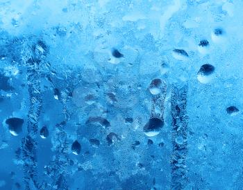 close up of frozen water drops on winter glass