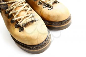 closeup of old yellow boots isolated on white