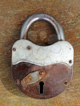 old rusty padlock on wooden background