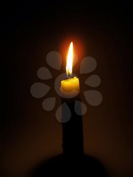 bright burning candle in the dark