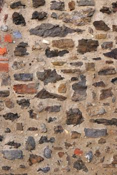 Ancient wall with stones and bricks, close-up texture