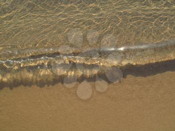 Transparent sea wave on the sand                     