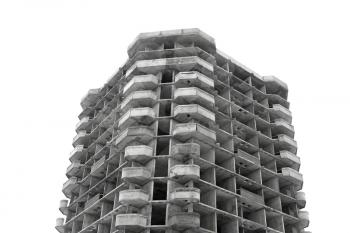 Unfinished high rise building concrete structure on white background